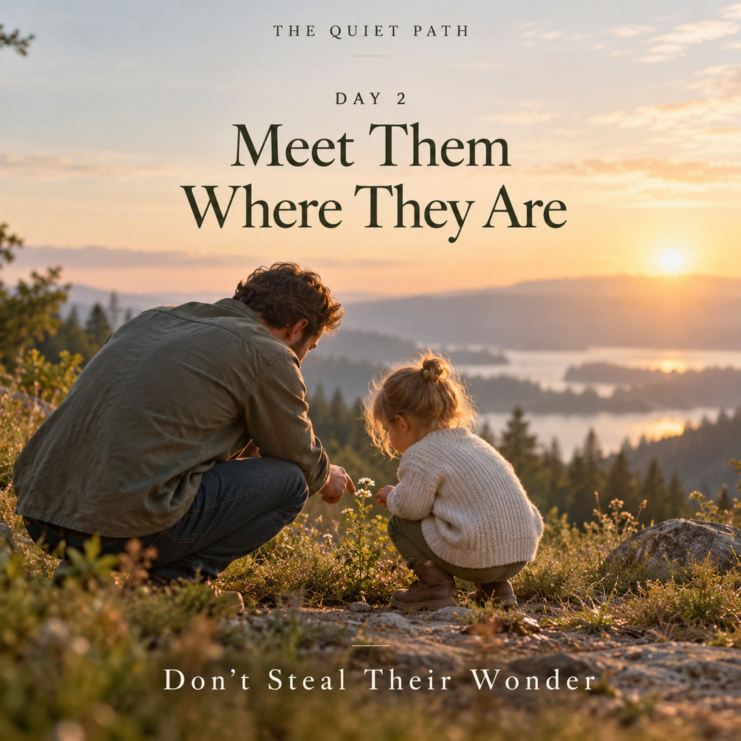 Day 2 · Meet Them Where They Are: a father kneels beside his small daughter as she looks at wildflowers on a hillside above a lake at sunrise. Text: THE QUIET PATH · DAY 2 · MEET THEM WHERE THEY ARE · DON’T STEAL THEIR WONDER